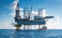 Offshore oil and gas drilling rig working on new wellhead remote platform to completion on gas and crude oil well, oil and gas exploration and production in the gulf of Thailand.